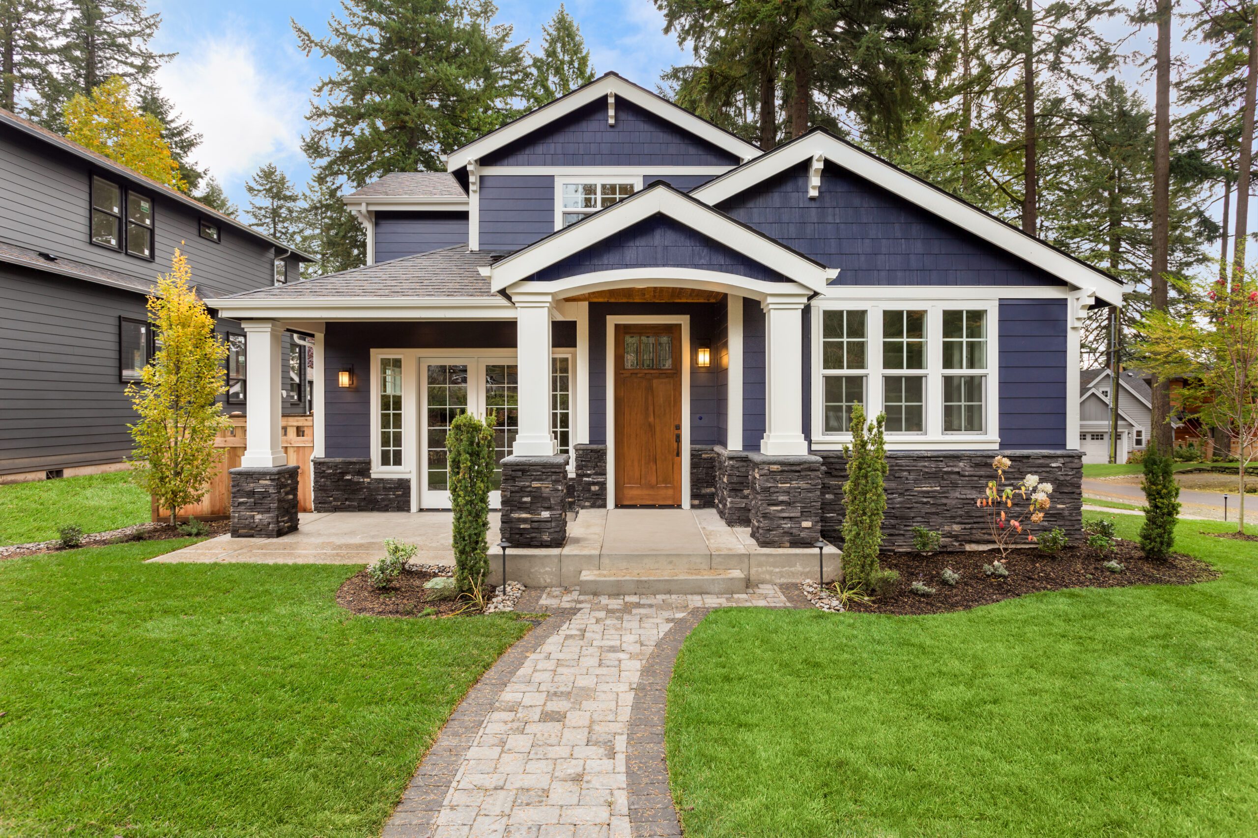 Blue house with landscaped front yard.